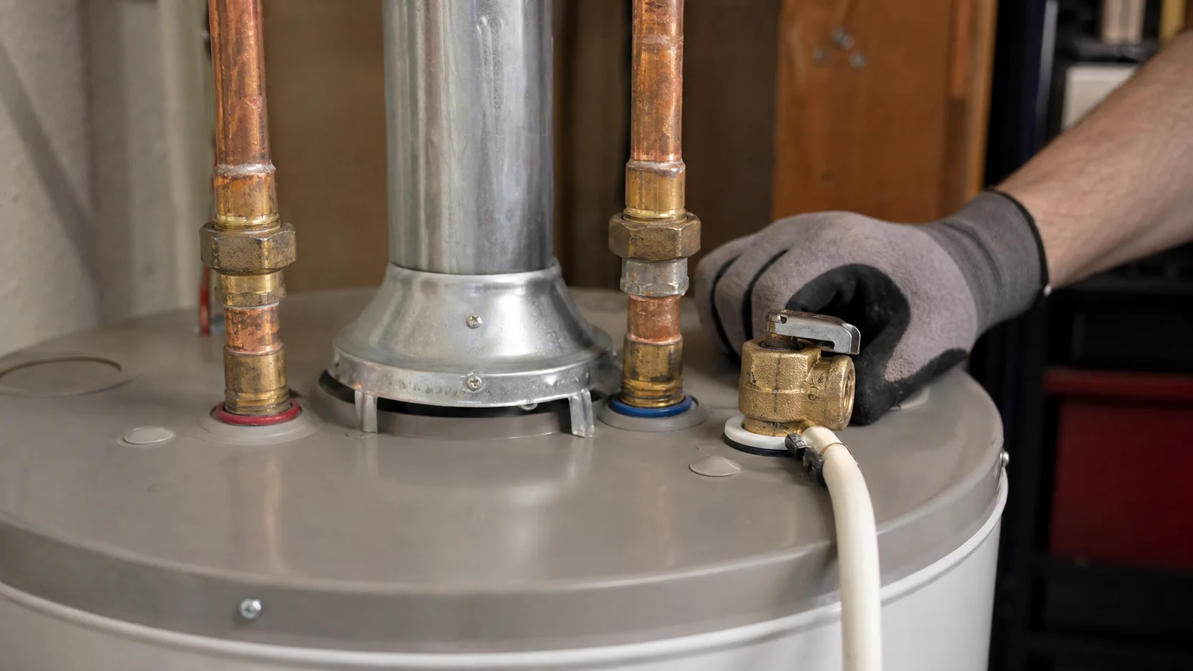 Top of a water heater showing the inlet, outlet, and pressure relief valve fittings.
